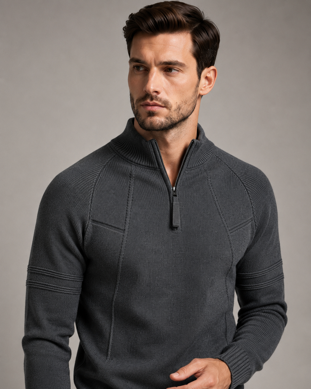 Charcoal gray fitted knit quarter-zip sweater with raglan sleeves, raised chest seams, and ribbed mock neck collar.