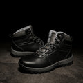 Black fleece-lined ankle boots with lace-up closure, padded collar, and rugged anti-slip sole