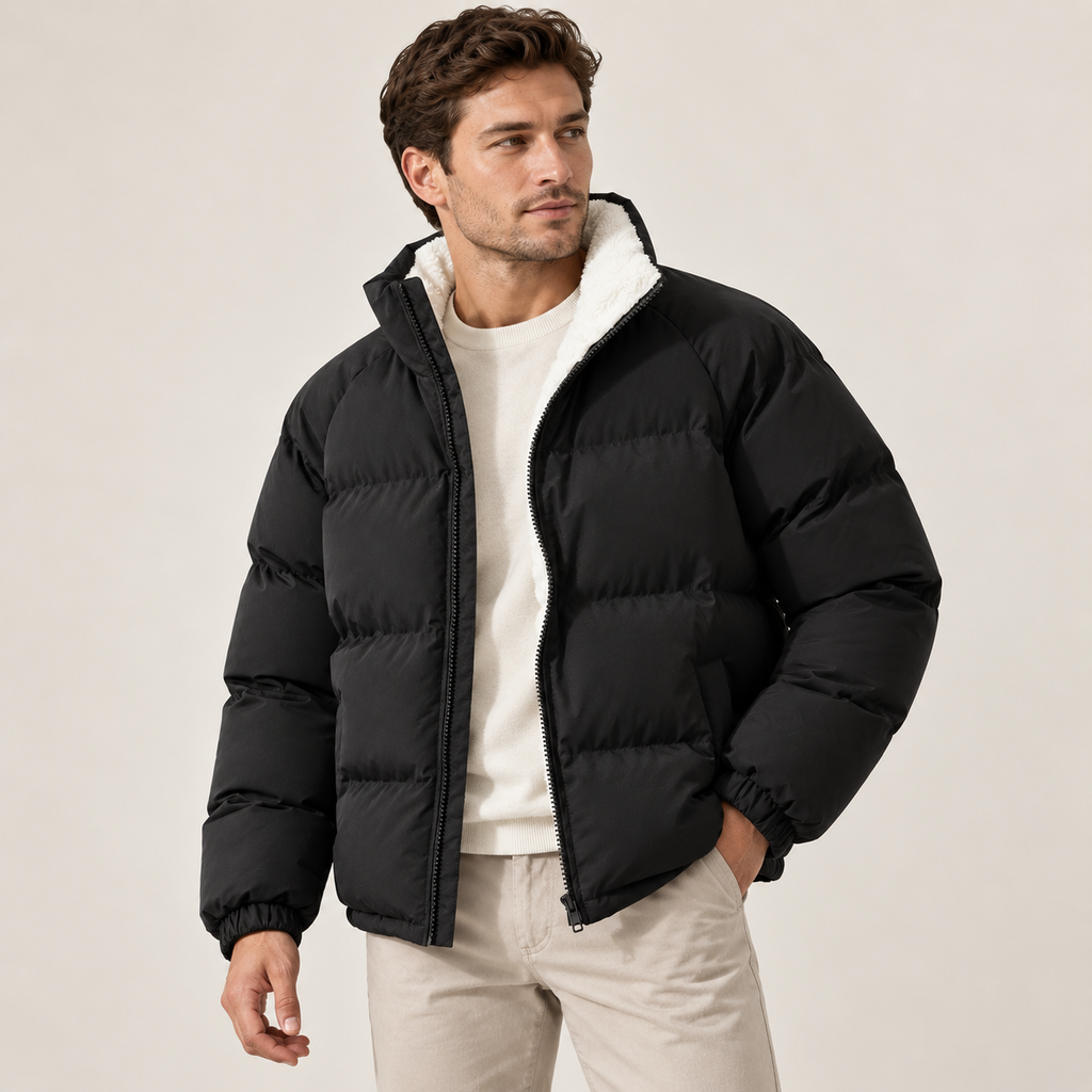A man wearing a black fleece-lined puffer jacket with a high collar and padded design