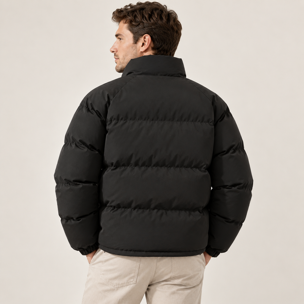 A man wearing a black fleece-lined puffer jacket with a high collar, shown from the back