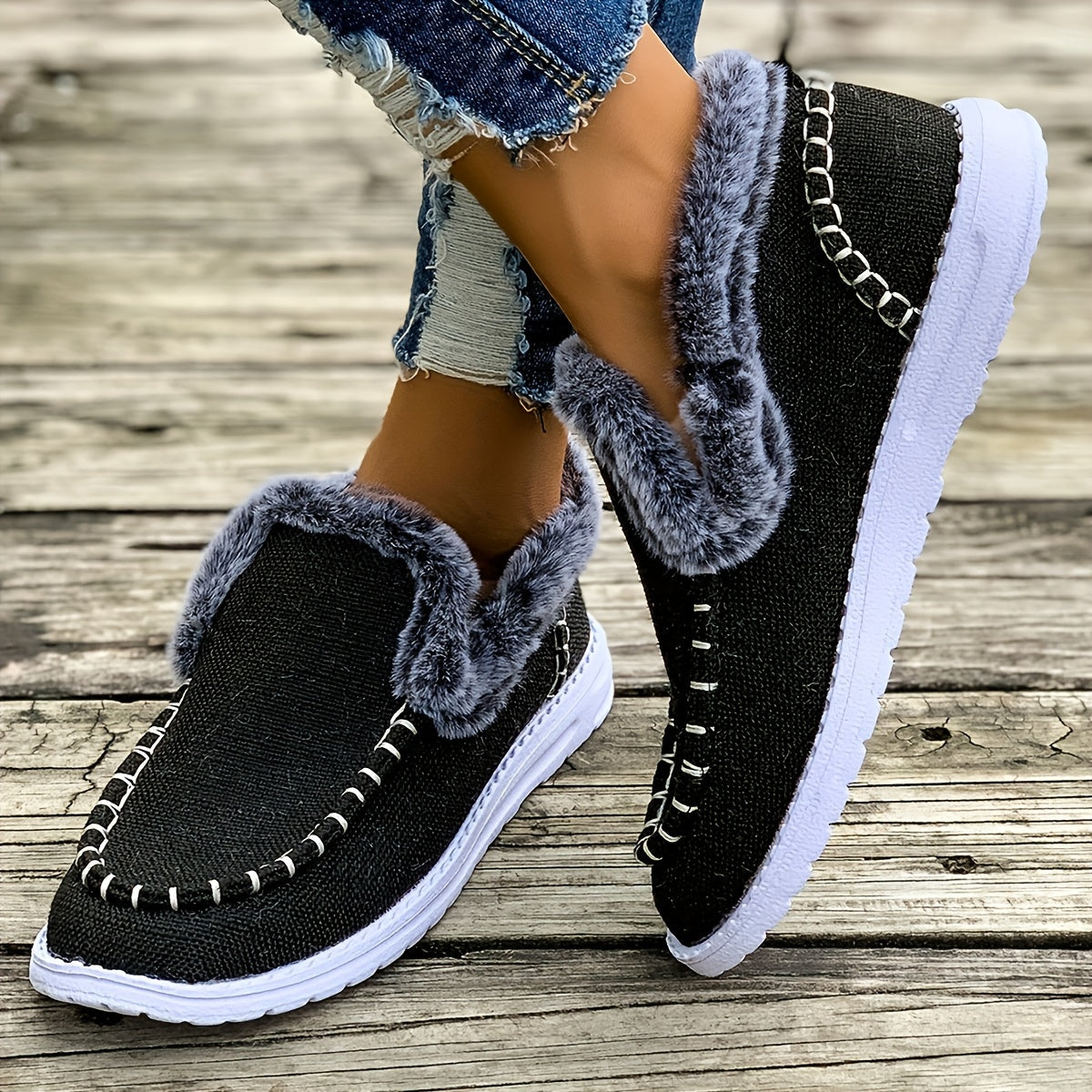 Black fleece-lined slip-on sneakers for women with soft fur lining and textured knit upper