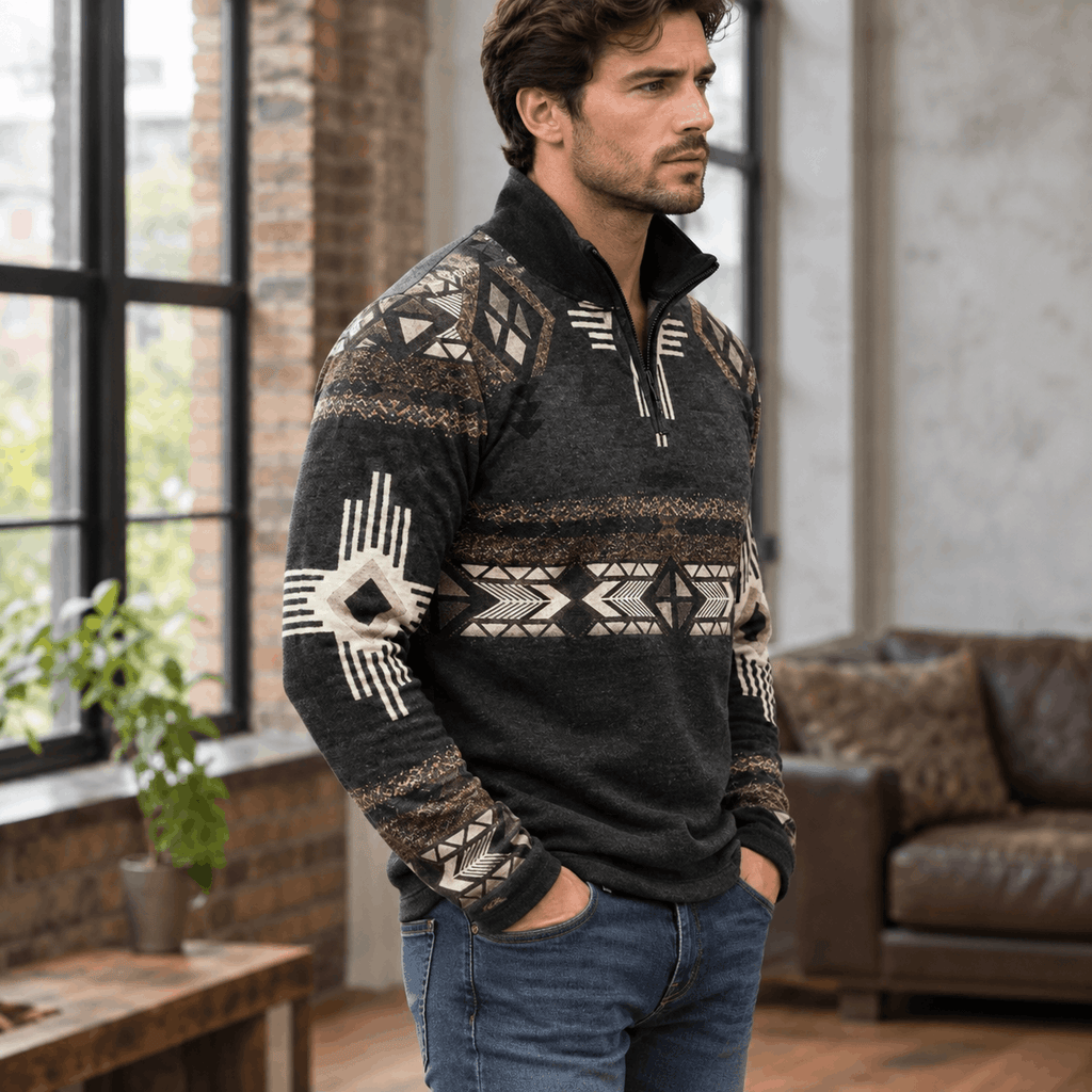 Black quarter-zip sweater featuring a geometric print, stand collar, and relaxed fit worn with blue denim jeans.