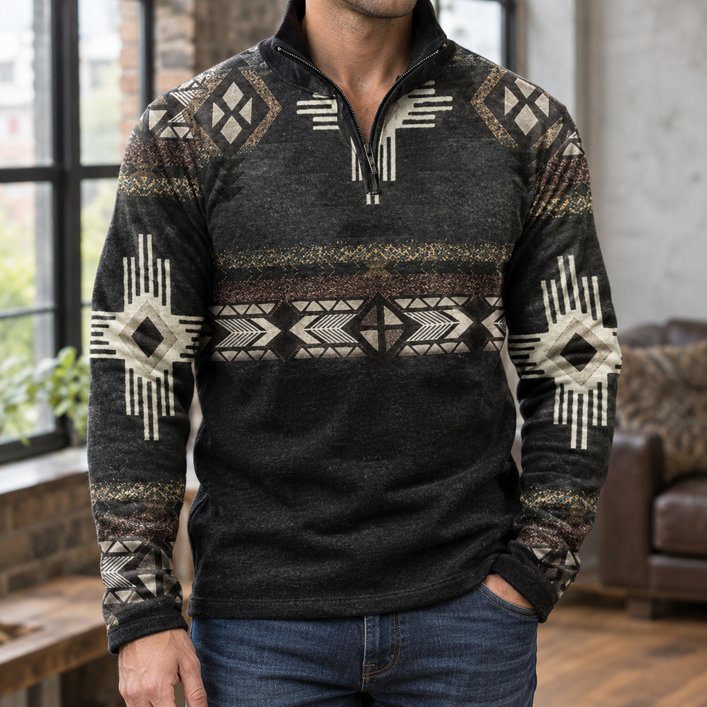 Black quarter-zip sweater featuring a geometric print, stand collar, and relaxed fit worn with dark denim jeans.