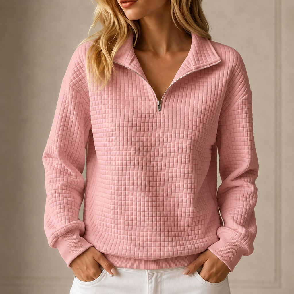 Pink grid-quilted half-zip sweatshirt worn by a female model
