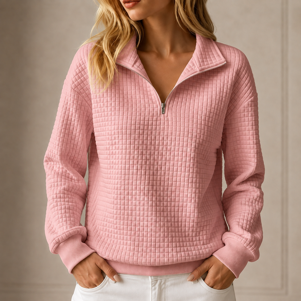 Pink grid-quilted half-zip sweatshirt worn by a female model