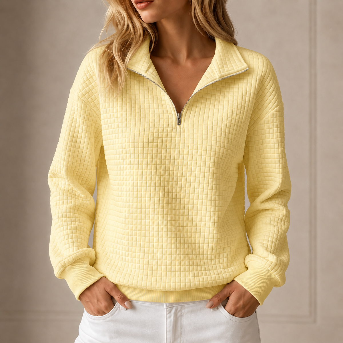 Yellow grid-quilted half-zip sweatshirt worn by a female model