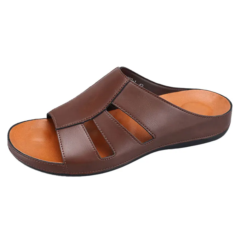 Side profile product shot of a dark brown leather slip-on sandal on a plain white background, showing the cutout straps and orange footbed.