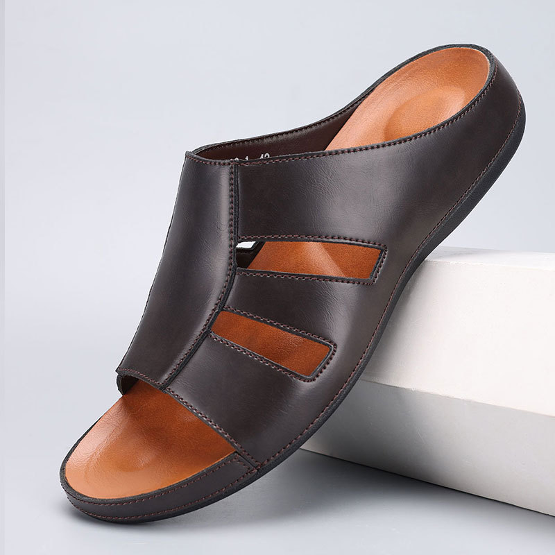 Chocolate brown leather slip-on sandal with cutout strap detailing and contrasting orange footbed, angled on a white display block.