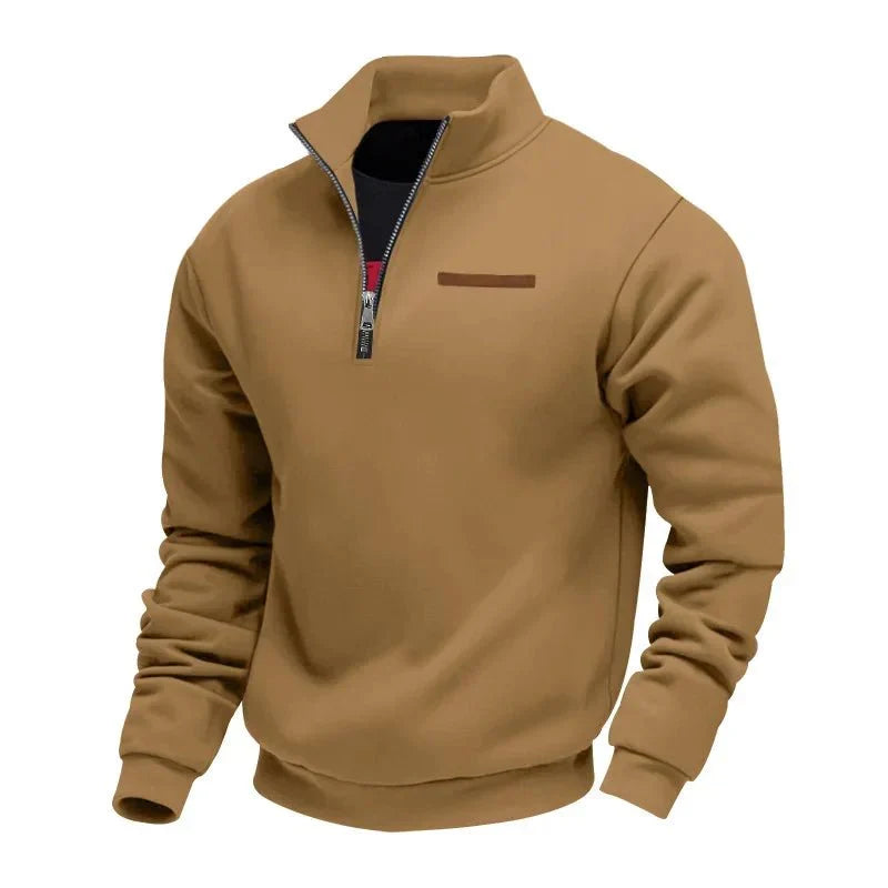 Tan half-zip fleece sweatshirt featuring a stand collar, ribbed cuffs, and chest accent detail on a white background.