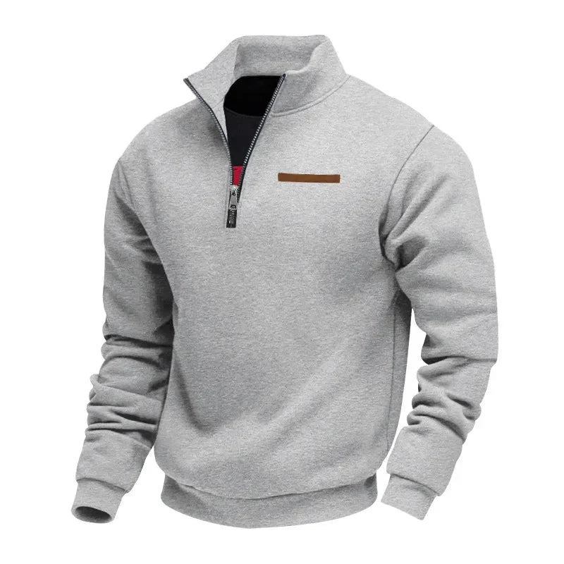 Light gray half-zip fleece sweatshirt with a stand collar, ribbed cuffs, and chest accent detail on a white background.