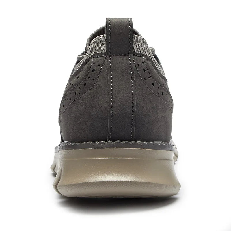 Rear view of a single gray suede sneaker showing the heel and outsole, on a plain white background.