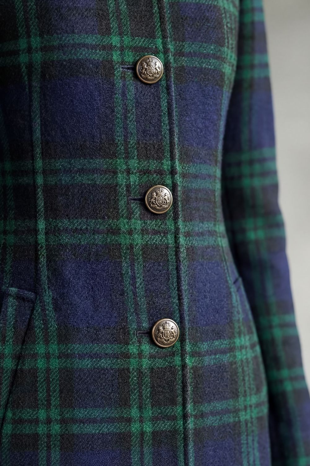 Tailored wool-blend coat in a dark green and navy Highland check with embossed gold-tone button-front closure.