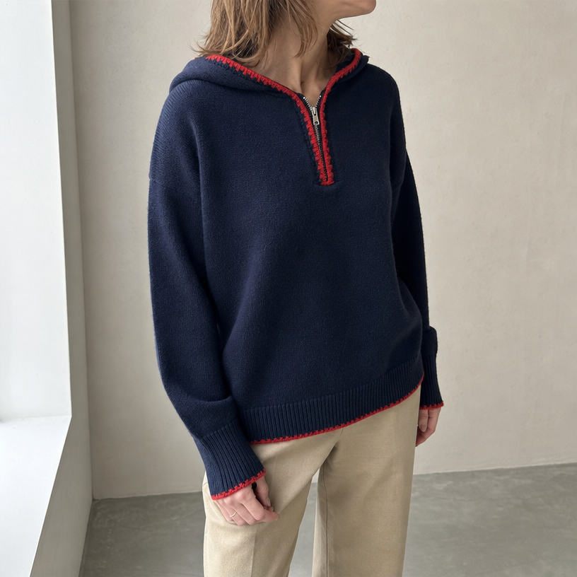 Navy hooded knit half-zip pullover worn by a female model, front view