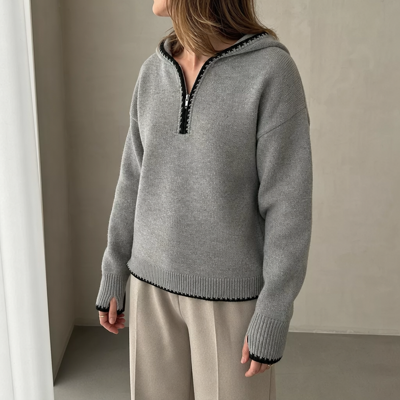 Hooded knit half-zip pullover worn by a female model in gray, front view