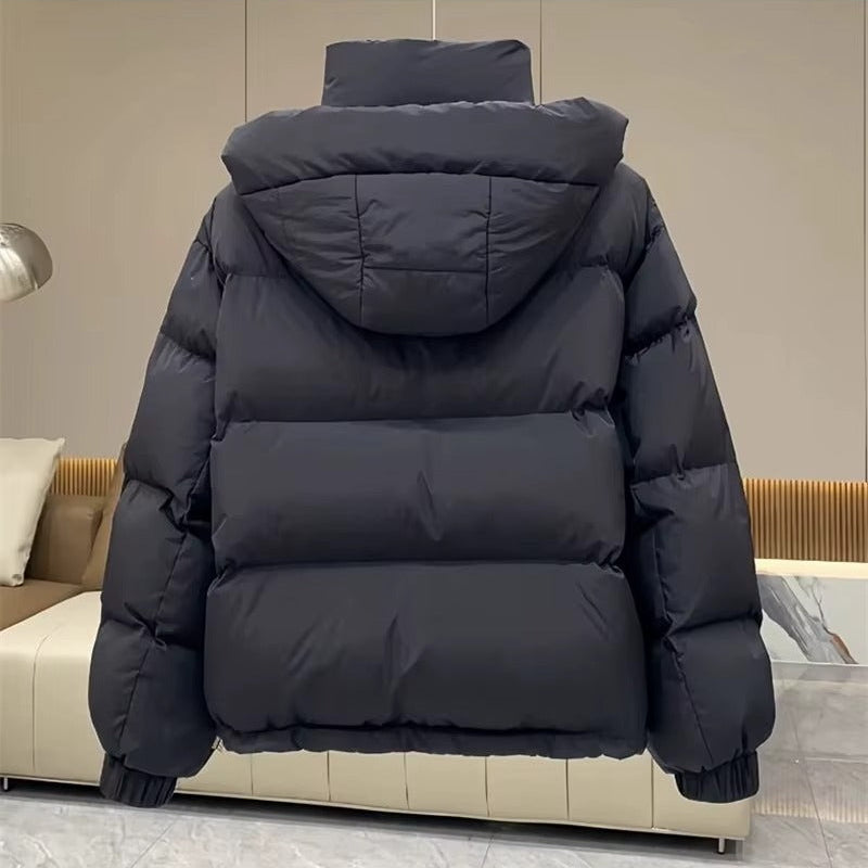 Black hooded puffer jacket with quilted insulation, high funnel neck, and relaxed fit, shown from the back.