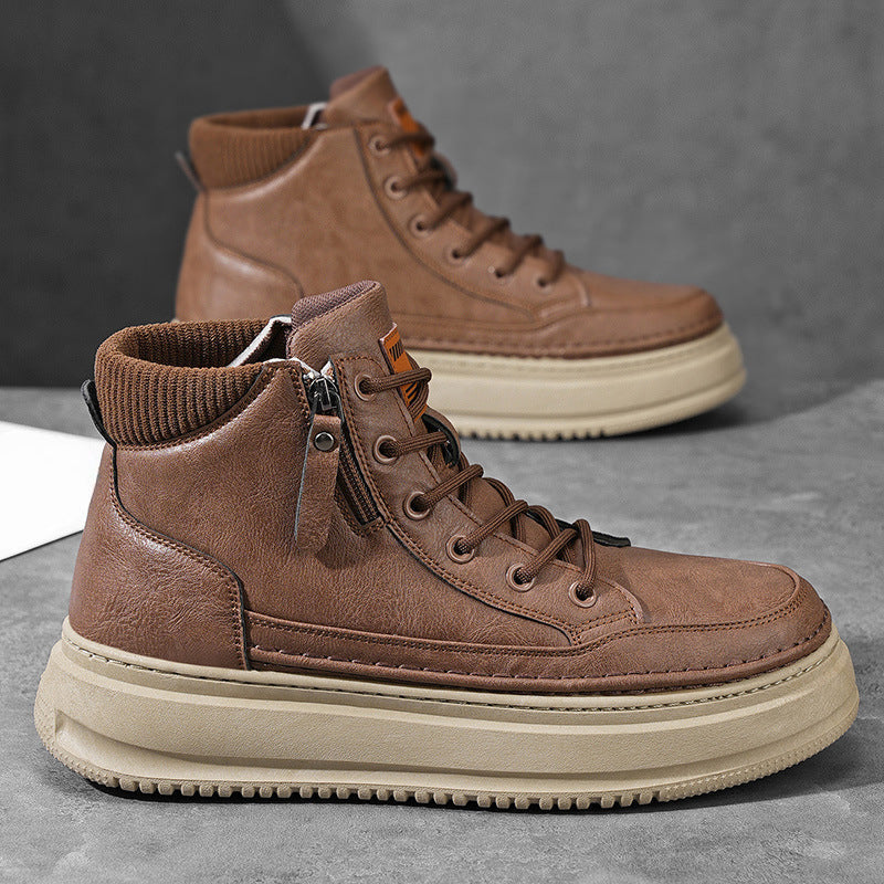 Pair of brown leather Hudson high-top sneakers with side zipper, orange pull tab, and cream platform sole