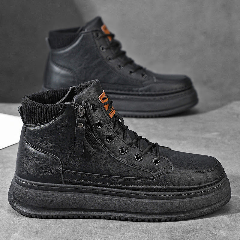 Pair of black leather Hudson high-top sneakers with side zipper, orange pull tab, and chunky platform sole
