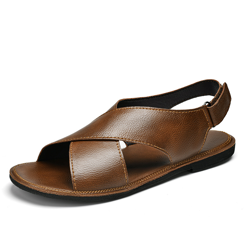 Side profile product shot of a brown leather cross-wrap sandal on a plain white background, showing the full silhouette from heel strap to open toe.