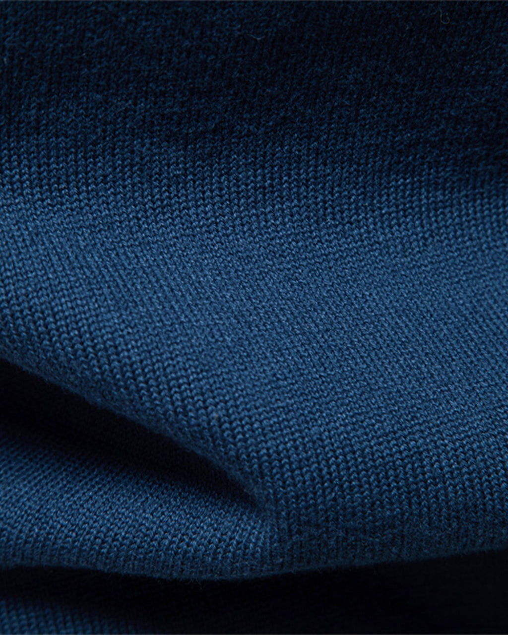 Close-up of the soft blue knit fabric showcasing the smooth texture and material quality.