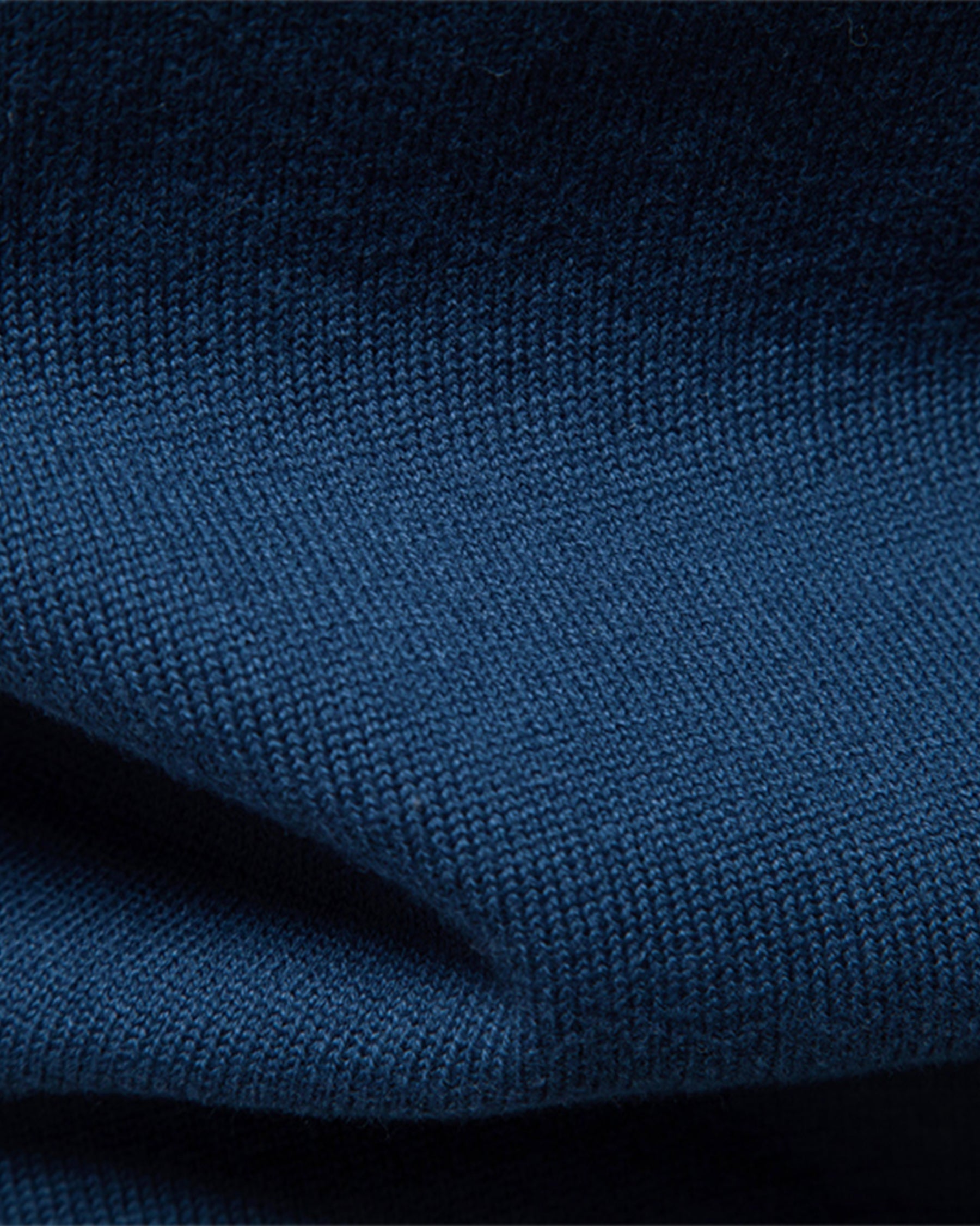 Close-up of the soft blue knit fabric showcasing the smooth texture and material quality.