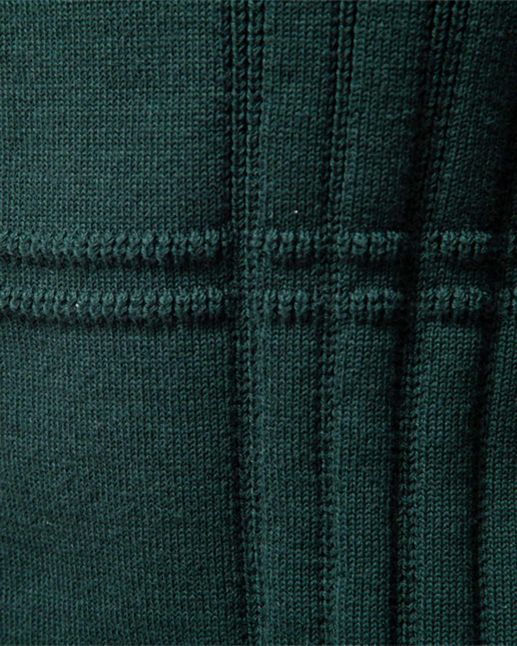 Close-up of the green textured knit sweater showcasing the ribbed vertical knit pattern.