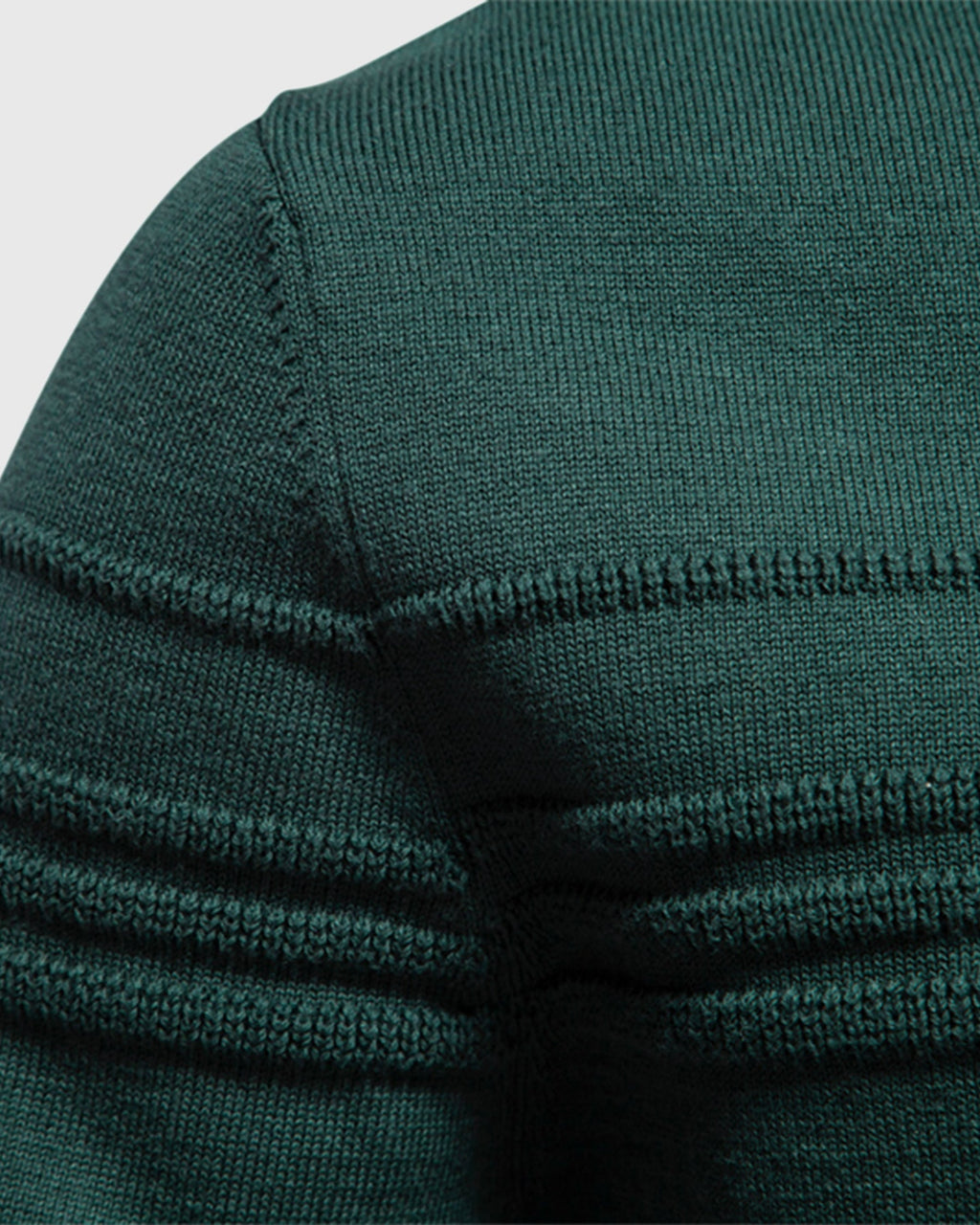 Close-up of forest green ribbed knit sweater shoulder seam detail