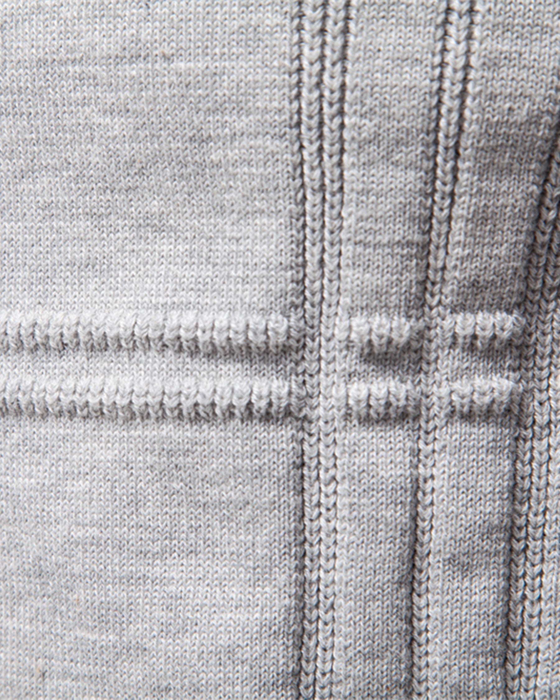 Close-up of light grey knit sweater textured stripe pattern