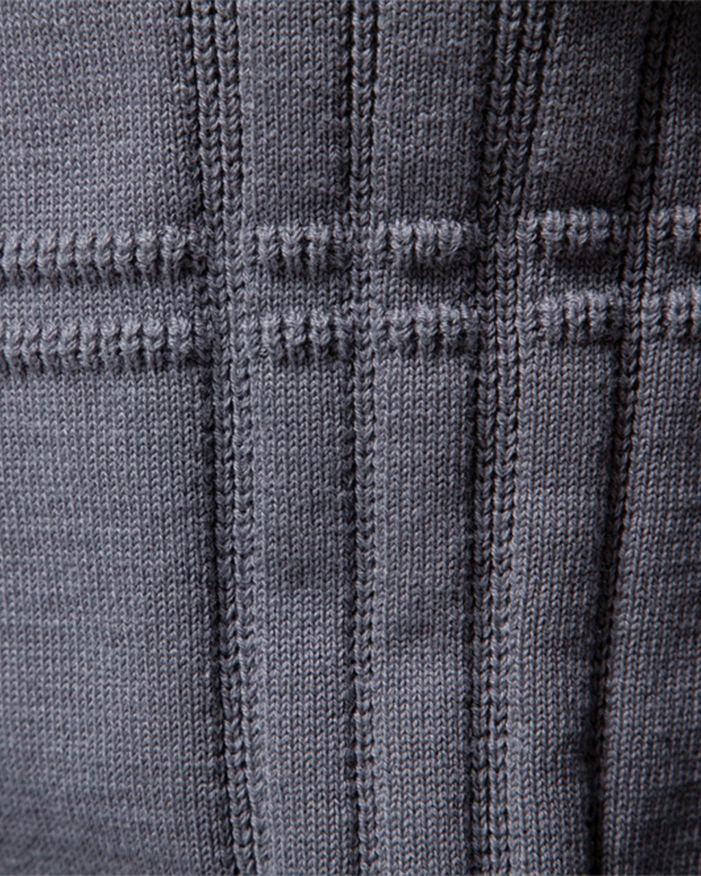 Close-up of the gray textured knit sweater showcasing the ribbed vertical knit pattern.