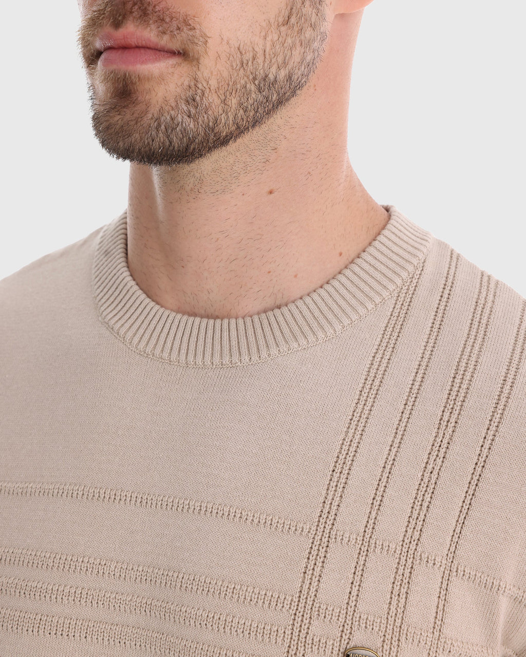 Man wearing beige textured knit sweater, close-up front chest view