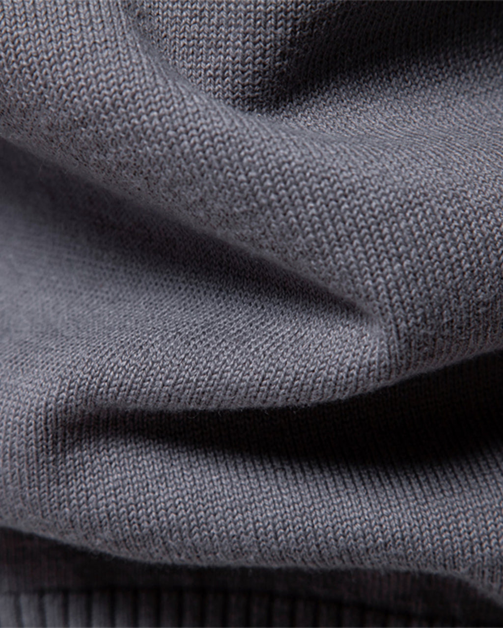 Close-up of the soft gray knit fabric showcasing the smooth texture and material quality.