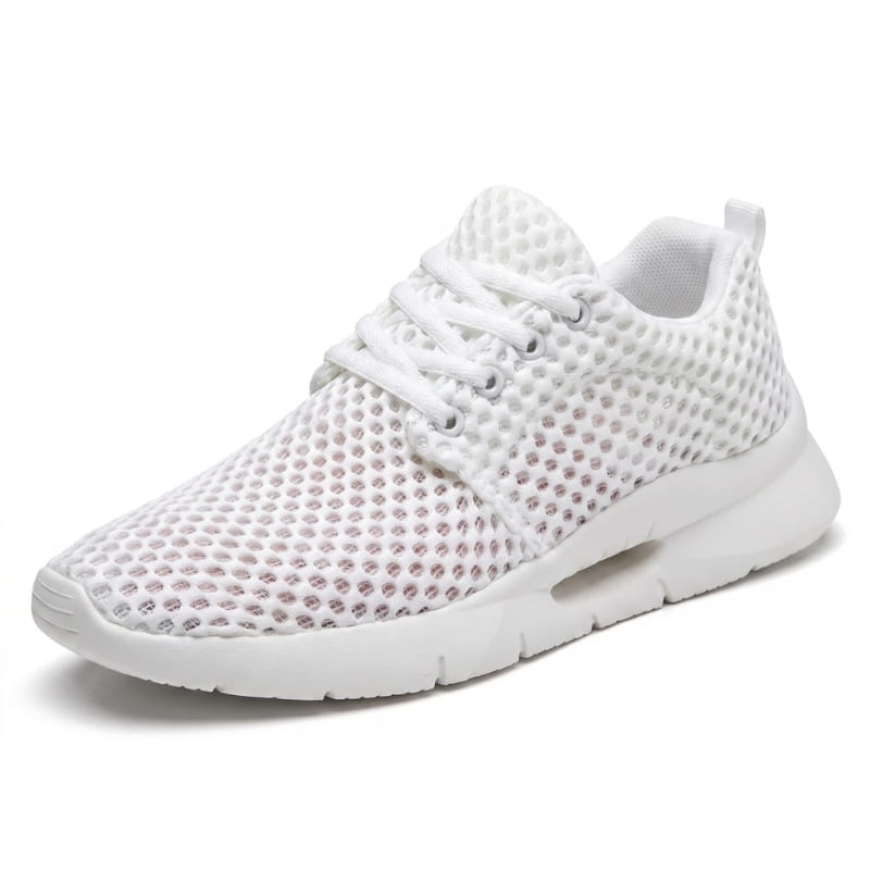 Side profile of a white mesh sneaker with textured cushioned sole on a plain white background