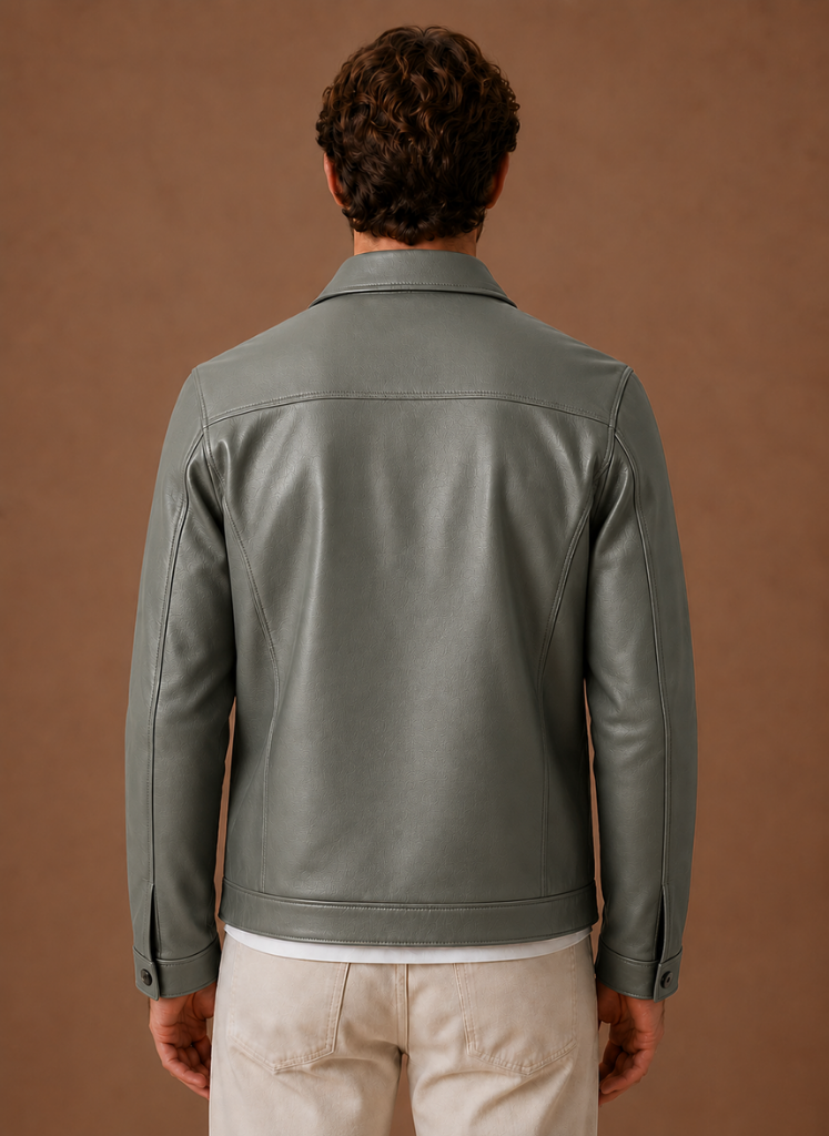 Back view of a man wearing a gray leather jacket with a classic shirt collar and clean tailored silhouette.