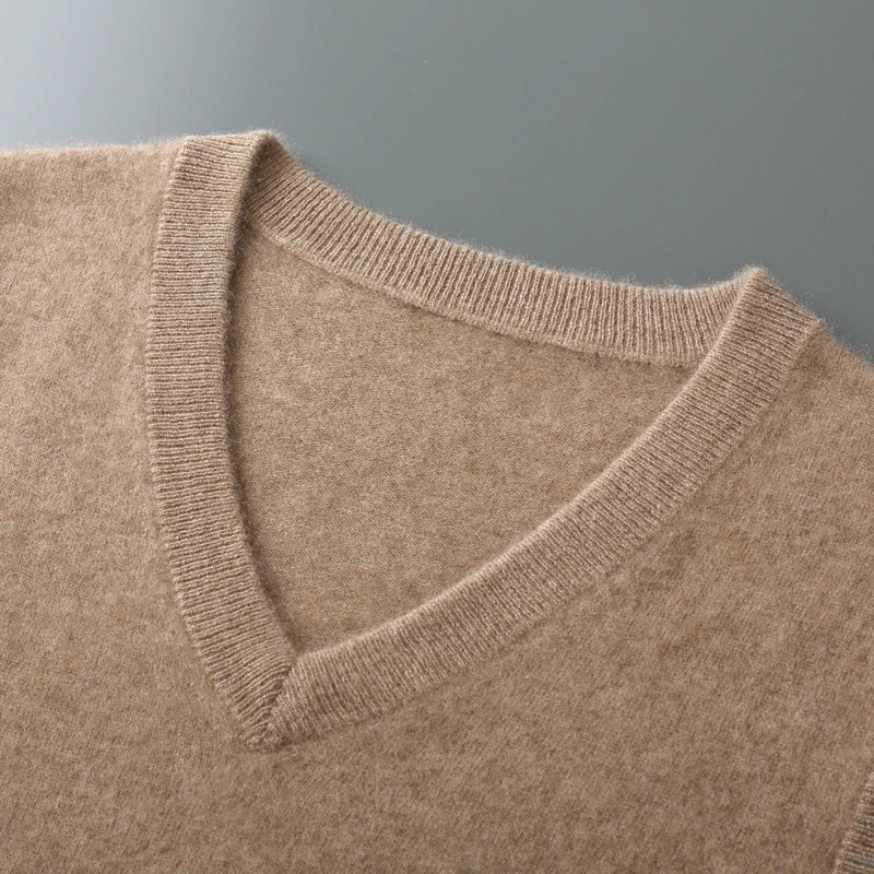 Close-up of the men's beige V-neck sweater vest highlighting the ribbed neckline and fine knit construction.