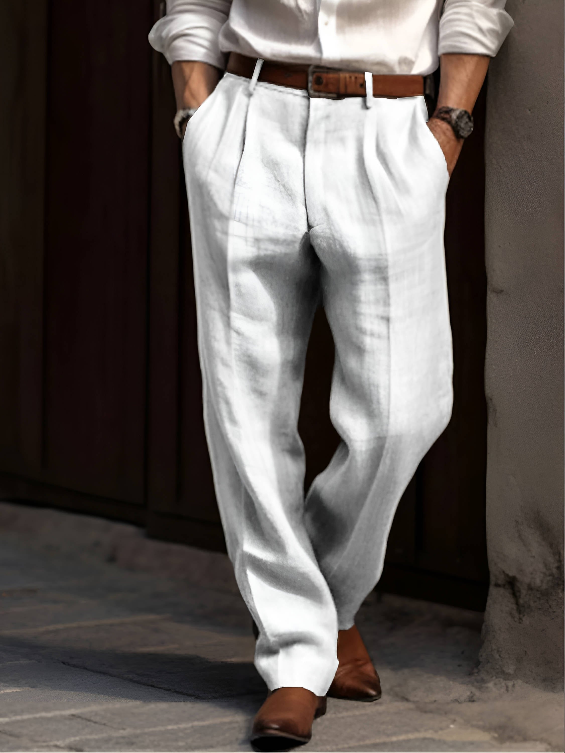 Man wearing light gray linen trousers with a pleated front, straight-leg silhouette, and tailored casual fit.