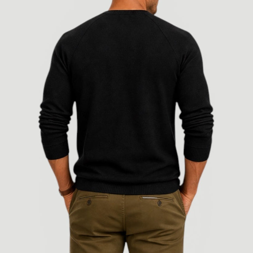 Back view of a men's black long-sleeve Henley sweater with a clean, minimalist design and ribbed hem.