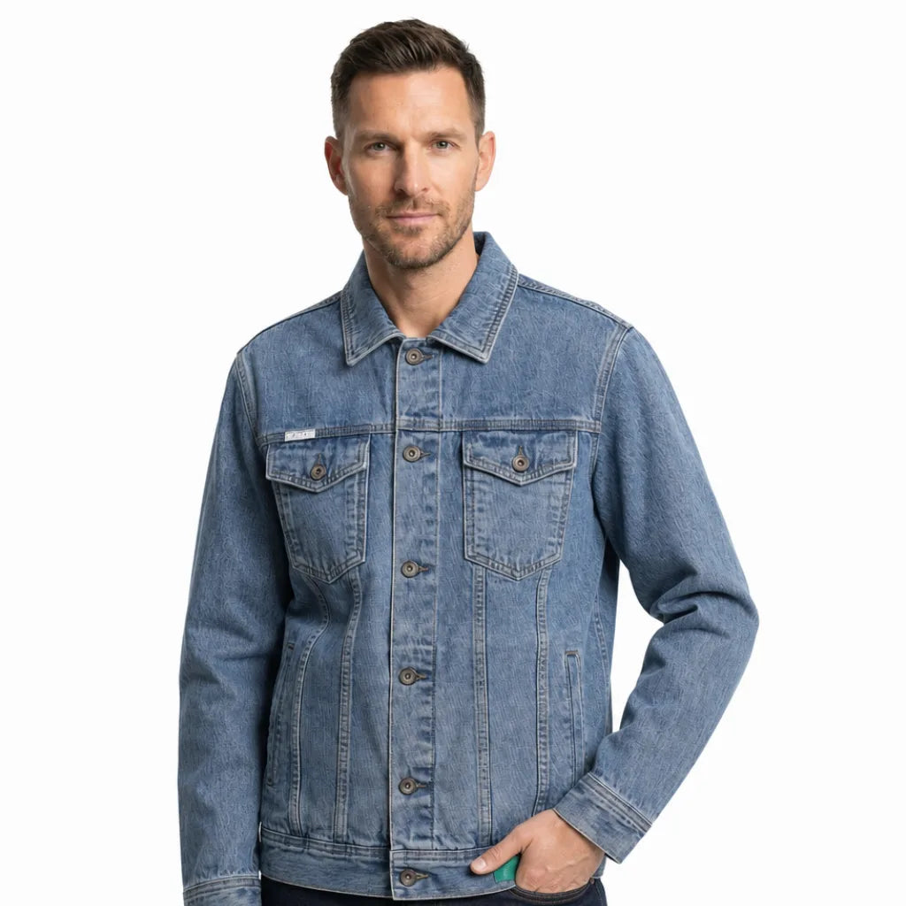 Man wearing a light wash denim jacket with a button-front closure, chest flap pockets, contrast stitching, and a classic trucker design.