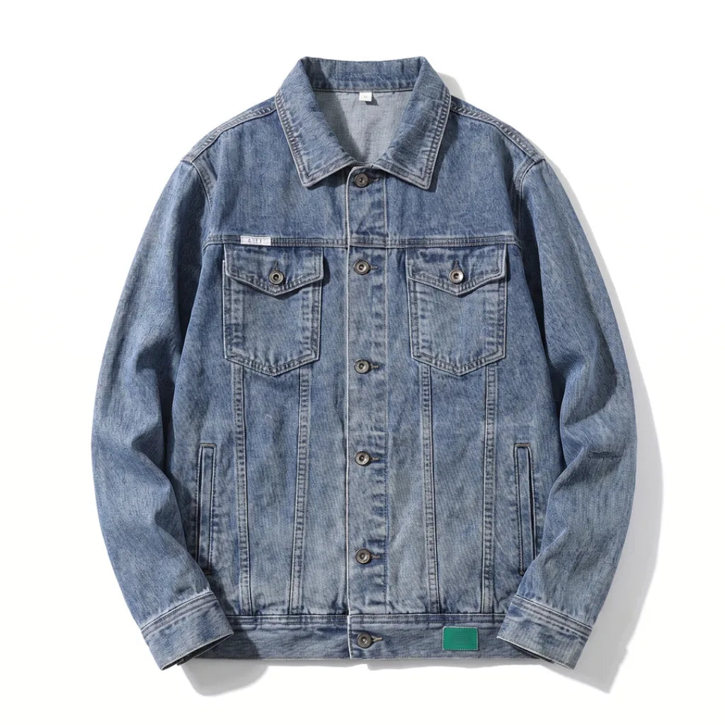 Men's light wash denim trucker jacket with a button-front closure, chest flap pockets, pointed collar, and classic regular-fit silhouette.