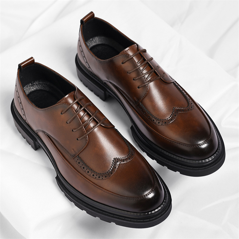 Top-down view of a pair of brown leather Julian brogue dress shoes standing upright, showing wingtip perforated detailing