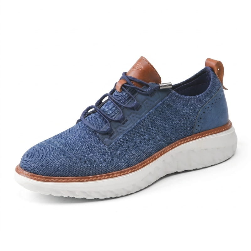 Side profile of a navy blue mesh sneaker with brown leather trim and white sole on a plain white background