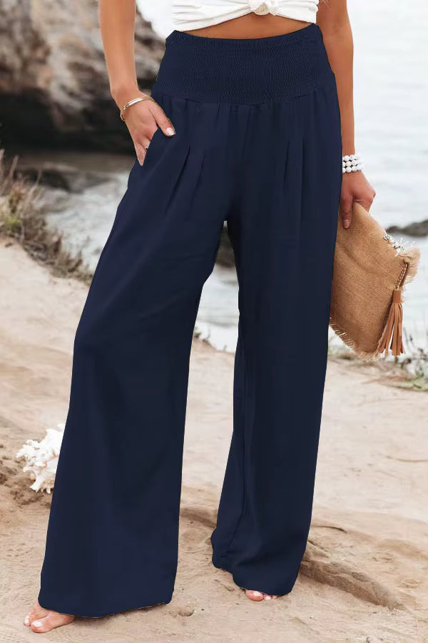 Women's navy blue high-waisted wide-leg linen pants with a relaxed silhouette and side pockets.