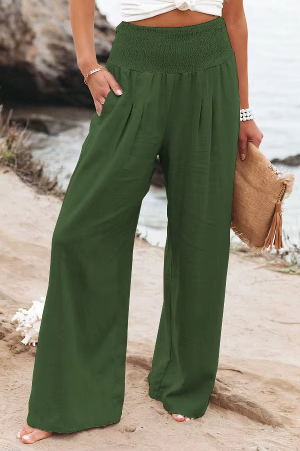 Women's dark green high-waisted wide-leg linen pants with a relaxed fit and lightweight linen fabric.