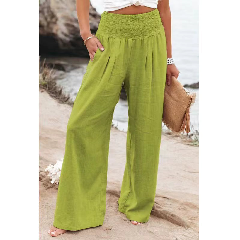 Women's light green wide-leg linen pants with a high-rise waist and loose, flowing silhouette.