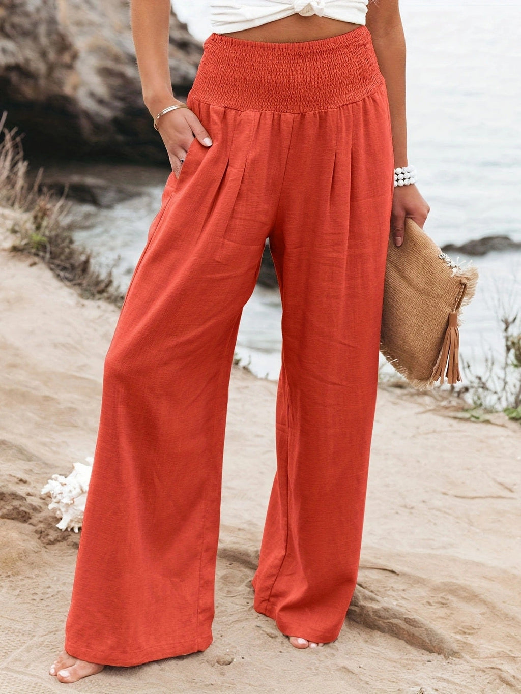 Women's coral wide-leg linen pants with a high waist, relaxed fit, and breathable linen fabric.