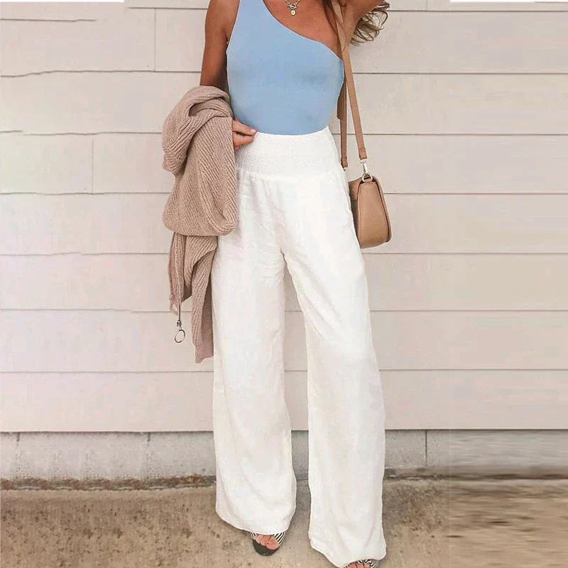 Women's cream wide-leg linen pants featuring a high waist, relaxed fit, and lightweight breathable fabric.