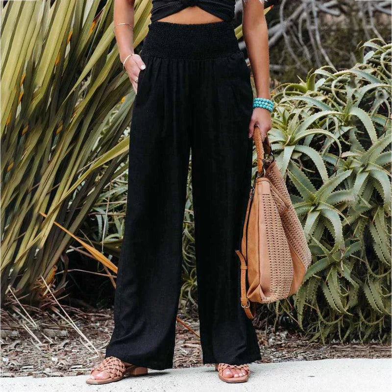Women's black wide-leg linen pants featuring a high waist, loose fit, and lightweight construction.