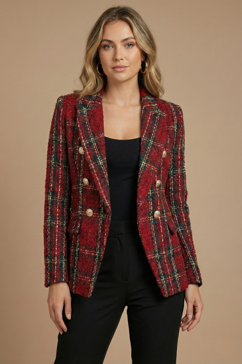 Woman wearing a red plaid tweed blazer with gold-tone buttons, notched lapels, and tailored silhouette over a black top and trousers.