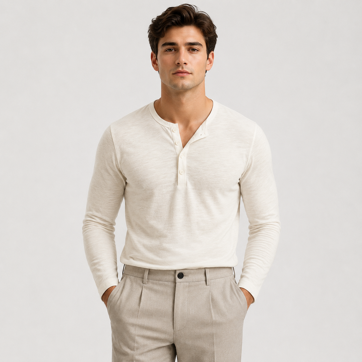 Man wearing a white long-sleeve Henley sweater featuring a three-button placket, ribbed cuffs, and a tailored fit.