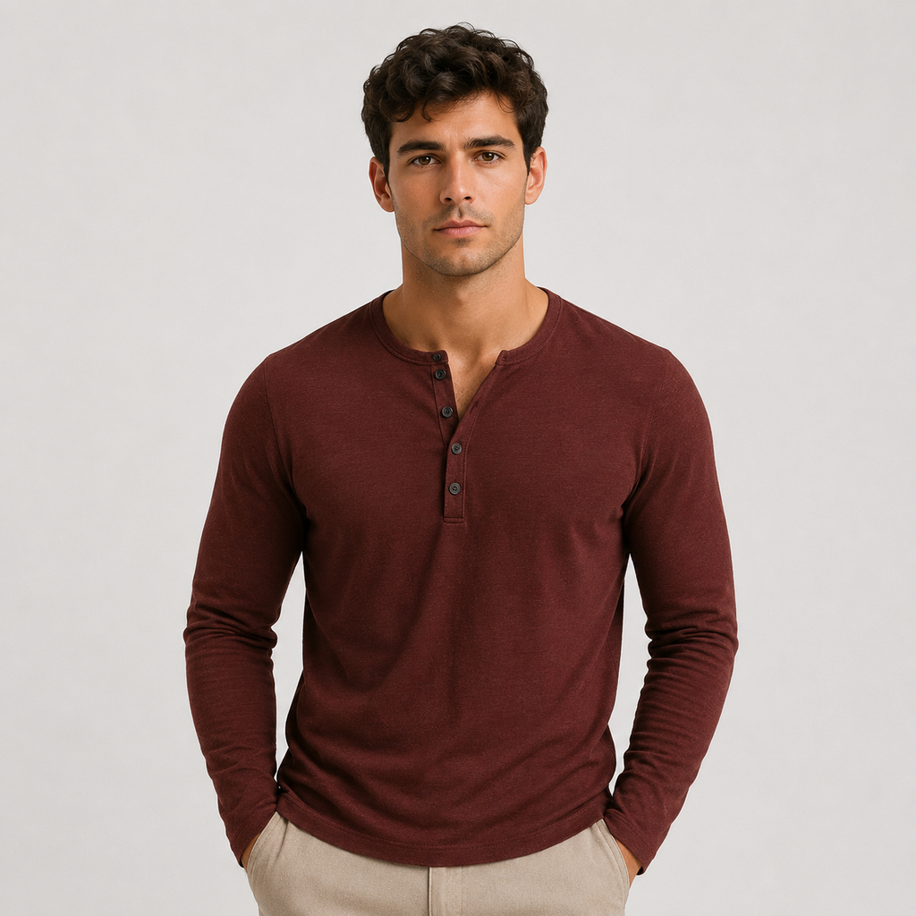 Man wearing a burgundy long-sleeve Henley sweater with a three-button placket, ribbed cuffs, and a modern slim fit.