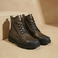 Brown leather ankle boots with fleece lining, side zip, and lace-up closure, three-quarter view
