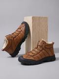 Tan fur-lined winter boots for men with a wide toe box, side zip, rugged sole, and lace-up design